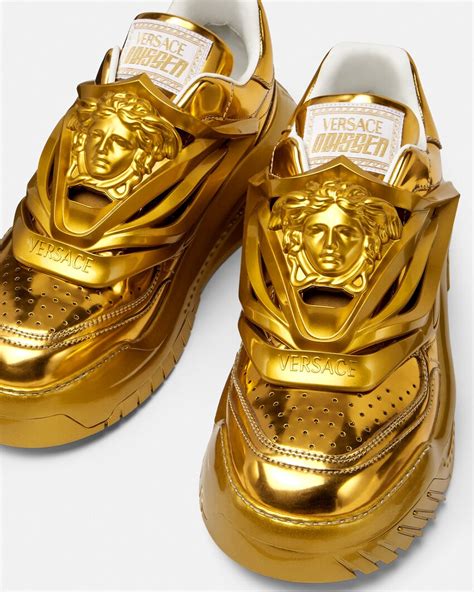 gold versace sneakers.